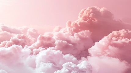 Fototapeta premium Fluffy clouds creating a dreamy effect on a pastel pink backdrop.