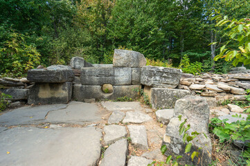 Archaeological site of dolmen or ancient burial and cult structure is located in the forest. Stone structure consists of large, carefully stacked stones with round hole in center. Gelendzhik 2014