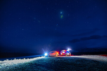 Trailer camper adventure under starry night sky in mountain landscape