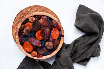 Organic sun dried fruits mix in bowl on white background. Healthy snacks instead of sugar and...