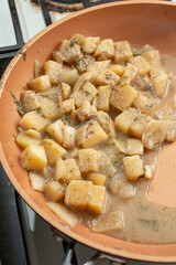 A view of sauteed kohlrabi cooking in a ceramic skillet.