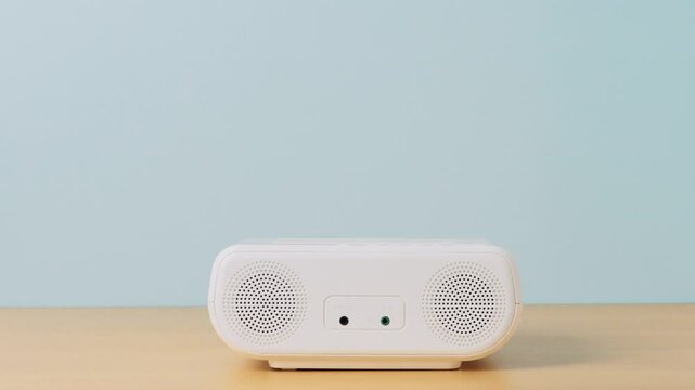 Girl putting a CD into a CD player or boombox. Person listening to music in a room.　CDプレイヤーまたはラジカセにCDを入れる女の子。部屋で音楽を聴く人。