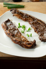 A view of a plate of teriyaki ribs.