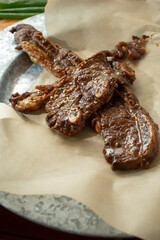 A view of some pieces of teriyaki ribs.