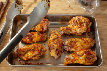 A view of a tray of dry rub chicken wings.