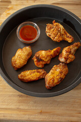 A top down view of a tray of dry rub chicken wings.