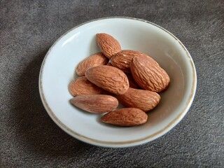 Bowl of Almonds on Textured Surface