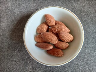Bowl of Almonds on Textured Surface