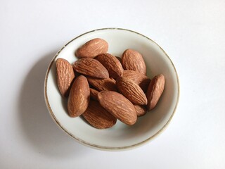 Bowl of Raw Almonds isolated on white background