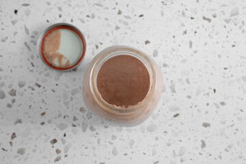 A top down view looking into a jar filled with chocolate bananamilk.