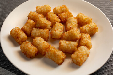 A view of a plate of tater tots.