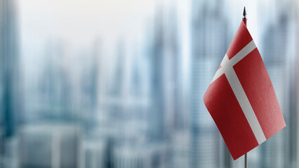 Small flags of the Denmark on an abstract blurry background