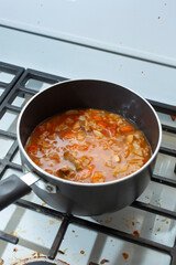 A view of a pot of tomato cabbage soup.