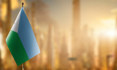 Small flags of the Djibouti on an abstract blurry background