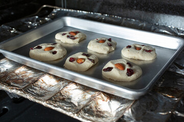 A view of cranberry almond cookies baking in the oven.