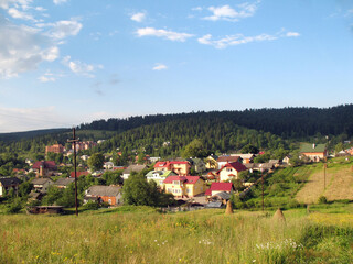 Idyllic countryside landscape with rolling hills and village