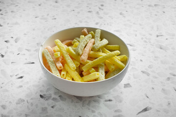 A view of a bowl of veggie stick chips.