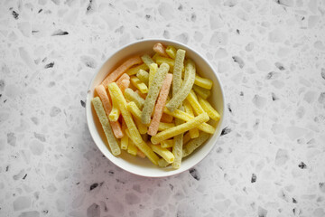 A top down view of a bowl of veggie stick chips.