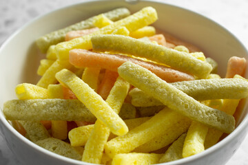 A closeup view of a bowl of veggie stick chips.