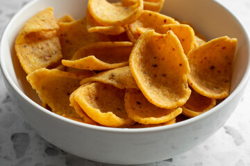 A closeup view of a bowl of corn chips.