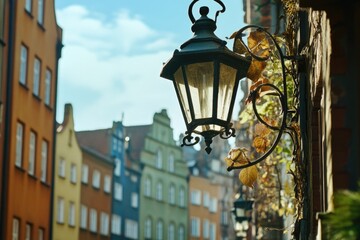 A city street light hangs from the side of a building, providing illumination in a urban environment