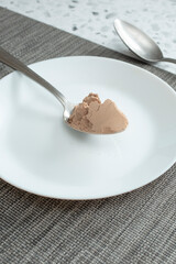 A view of a spoonful of protein shake powder.
