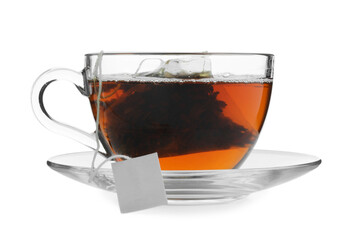 Tea bag in glass cup with hot drink isolated on white