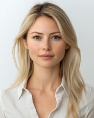 Portrait of a young woman with blonde hair and light eyes, wearing a cream-colored shirt, against a white background.