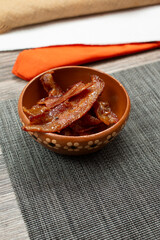 A view of a small bowl of peanut butter bacon.