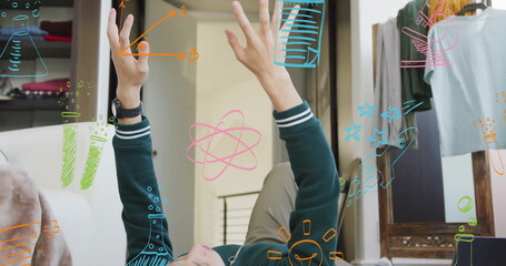 Image of science icons over caucasian man bouncing ball in room