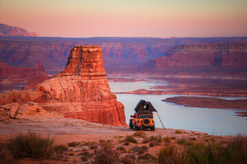 Yellow Truck Rooftop Tent Camping Overlooking a Desert Lake at Sunset