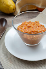 A view of a small glass bowl of guava puree.