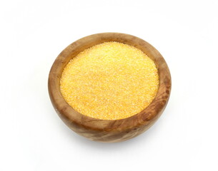 Polenta or corn flour in a wooden bowl isolated on white. Heap of cornmeal isolated on white background. Corn grits. 