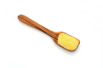 Polenta or corn flour in a wooden spoon isolated on white. Heap of cornmeal isolated on white background. Corn grits. 