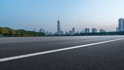 Panoramic View of a City Skyline with a Clear Road in the Foreground