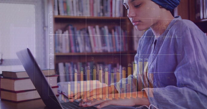 Image of diagrams over biracial female student using laptop