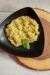 A top down view of a plate of spaghetti squash Alfredo.
