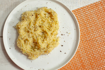 A top down view of a plate of spaghetti squash Alfredo.