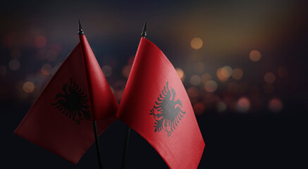 A small Albania flag on an abstract blurry background