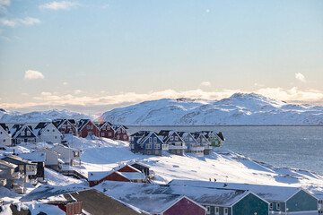 Nuuk the capital of Greenland.  Beautiful colored houses in a sunny winter landscape by the sea
