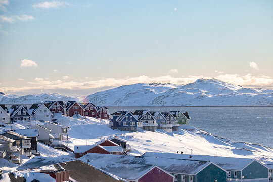 Fototapeta Nuuk the capital of Greenland.  Beautiful colored houses in a sunny winter landscape by the sea