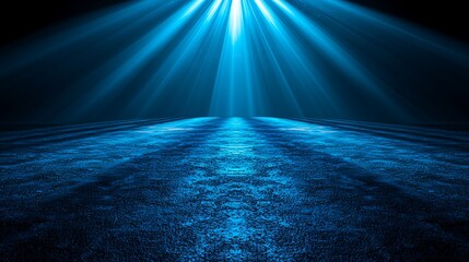 Blue spotlight illuminates dark stage floor, background black