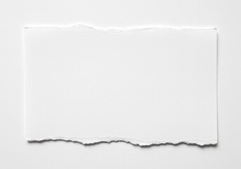 Obraz premium Photograph of a blank white sheet of paper with uneven, jagged edges, showing a rough, textured surface and placed on a solid white background.