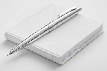 Minimalist Silver Pen on a White Notebook