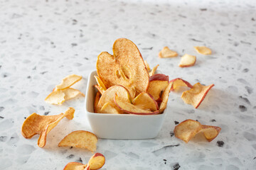A view of a pile of pink lady apple chips, as a background.