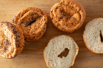 A top down view of a layer of gluten free everything bagels.