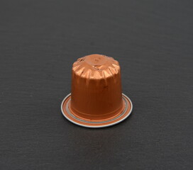 Used coffee capsules on black background