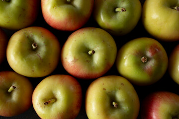 A top down view of of a layer of crimson gold apples, as a background.