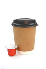  coffee espresso capsules or coffee pods and disposable cardboard cup on isolated white background. Can be used as an element for your design 