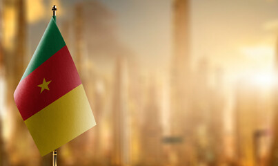 Small flags of the Cameroon on an abstract blurry background